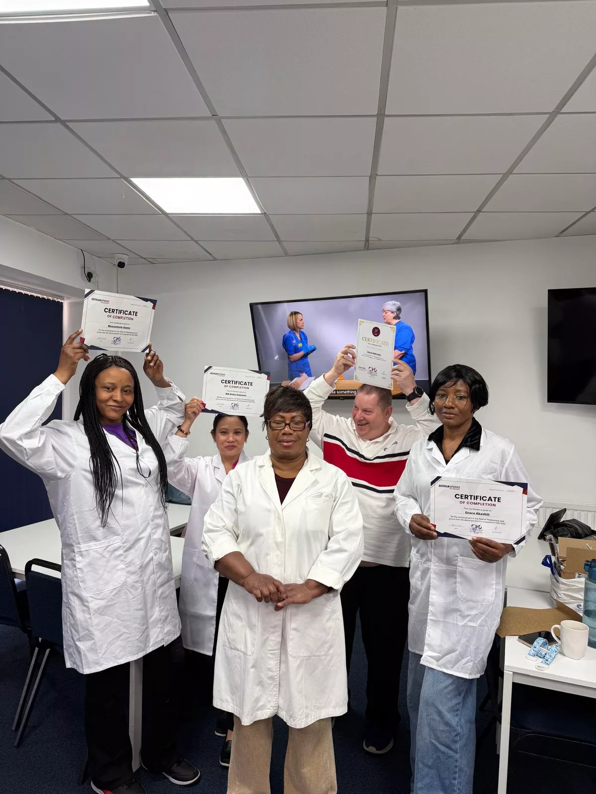 Estella Sparks graduates holding their certificates